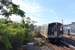 A northbound S train of R179 cars arrives into Howard Beach-JFK Airport Station 